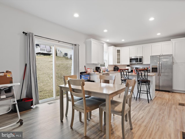 dining room with recessed lighting, light wood-style flooring, and visible vents