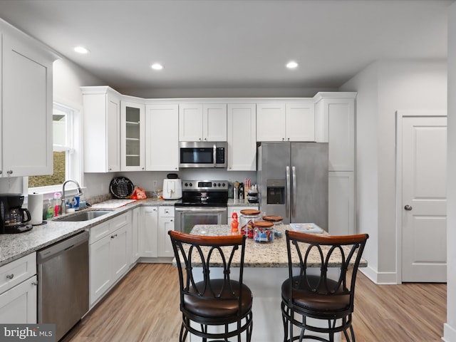 196 Kelley Rd, Fredericksburg, VA 22405 - kitchen with white cabinets, a breakfast bar area, appliances with stainless steel finishes, and a sink