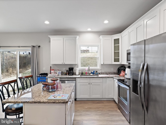 196 Kelley Rd, Fredericksburg, VA 22405 - kitchen with white cabinets, appliances with stainless steel finishes, a kitchen breakfast bar, and a sink