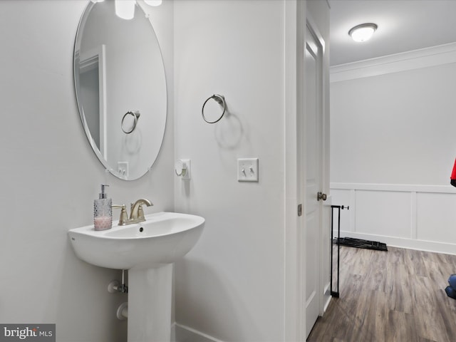 196 Kelley Rd, Fredericksburg, VA 22405 - bathroom featuring a decorative wall, wood finished floors, a wainscoted wall, and ornamental molding