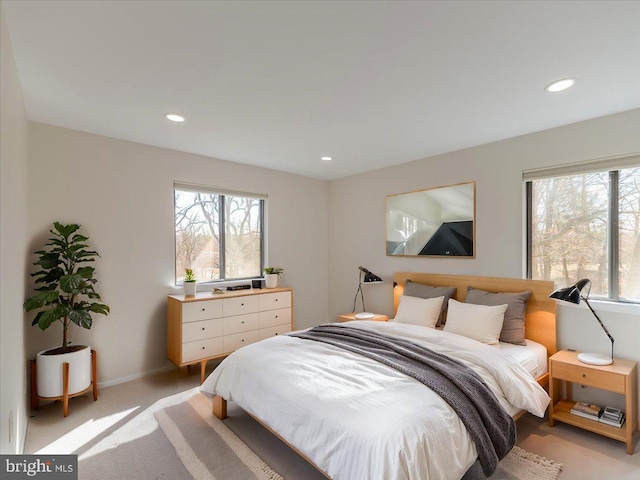 bedroom featuring light carpet, baseboards, and recessed lighting