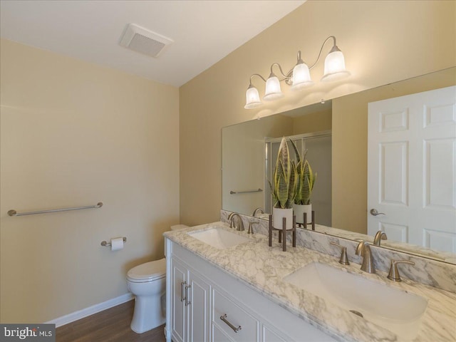 full bath featuring a stall shower, visible vents, a sink, and toilet