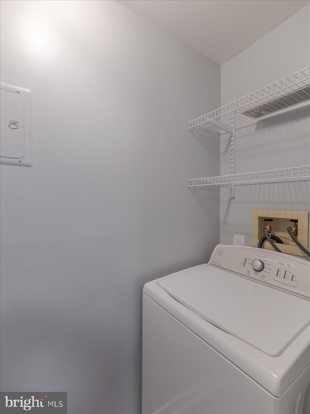 washroom with laundry area and washer / dryer