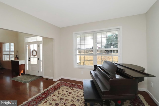 entrance foyer featuring baseboards and wood finished floors