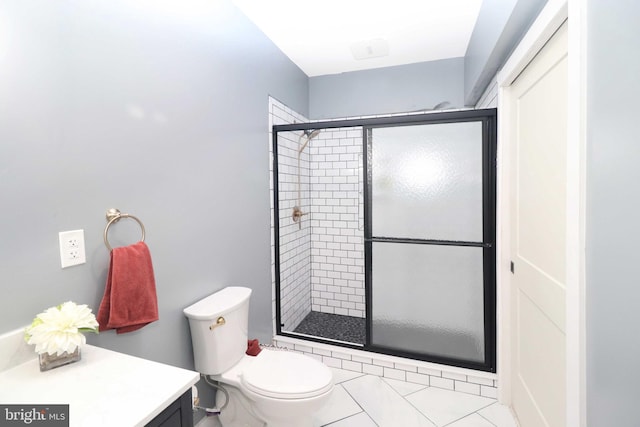 bathroom with toilet, a stall shower, vanity, and tile patterned flooring