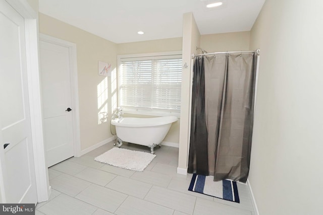 bathroom with a shower with curtain, baseboards, recessed lighting, a freestanding bath, and tile patterned flooring