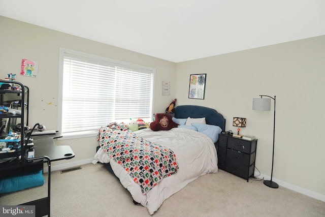 carpeted bedroom with visible vents and baseboards