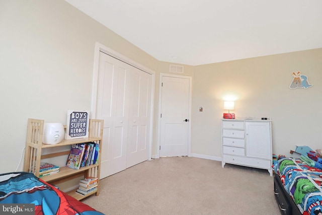 bedroom featuring a closet, carpet flooring, and visible vents