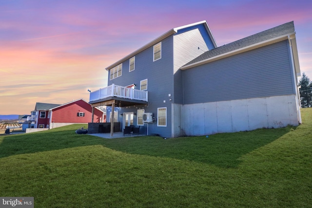 rear view of property with a patio area and a lawn