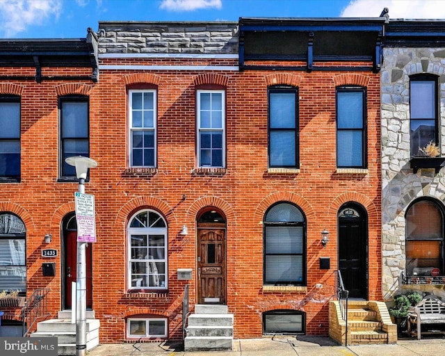 view of property featuring brick siding and entry steps