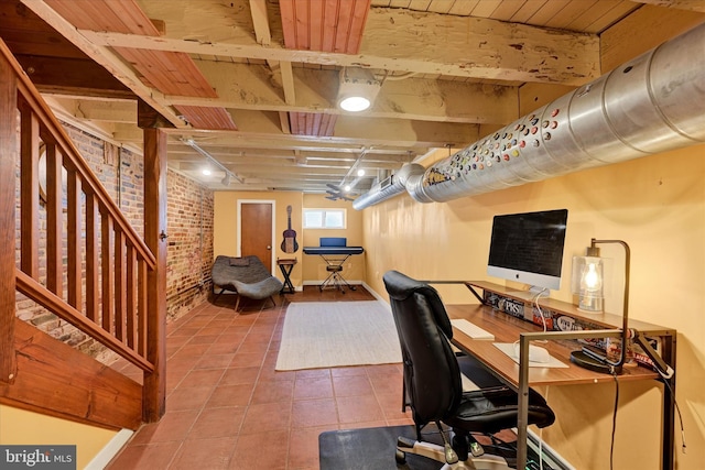 tiled office featuring brick wall