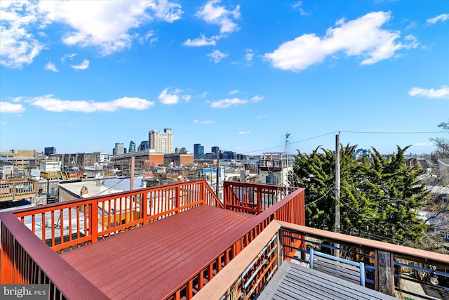 wooden terrace featuring a city view