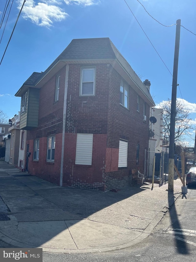 view of side of property with brick siding