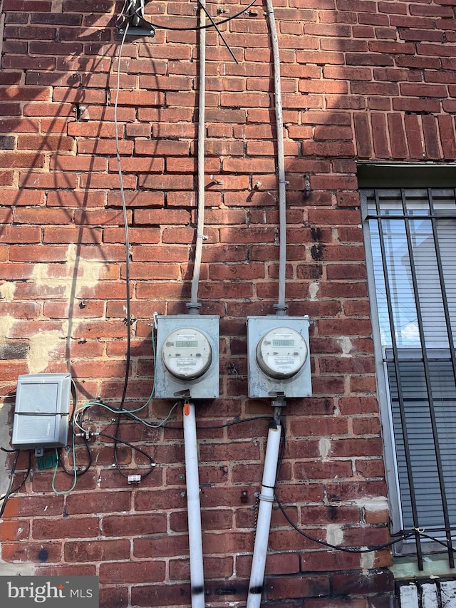 exterior details with brick siding and electric meter