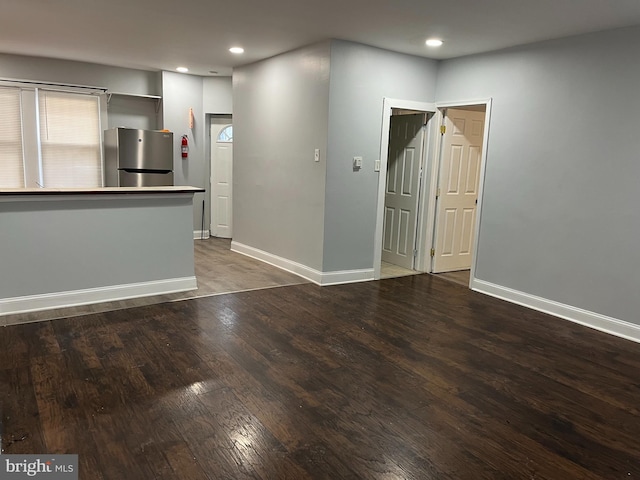 interior space featuring recessed lighting, wood finished floors, and baseboards