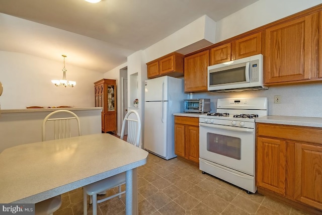 kitchen with white appliances, a notable chandelier, brown cabinetry, and light countertops