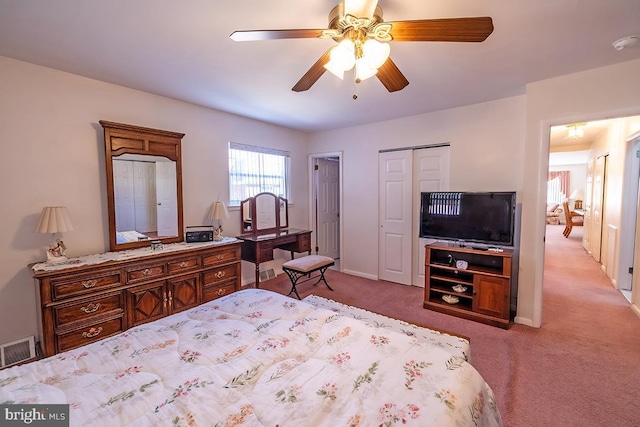 carpeted bedroom featuring visible vents, baseboards, a closet, and a ceiling fan