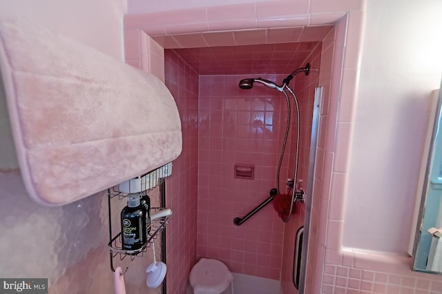 bathroom featuring tile walls and a stall shower