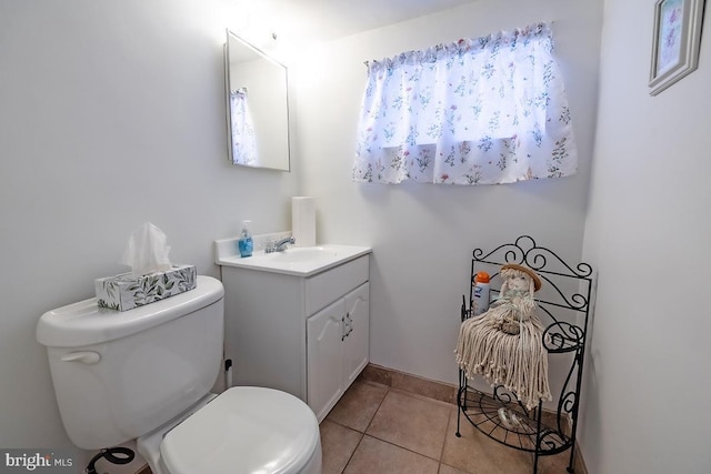 bathroom featuring vanity, tile patterned floors, and toilet