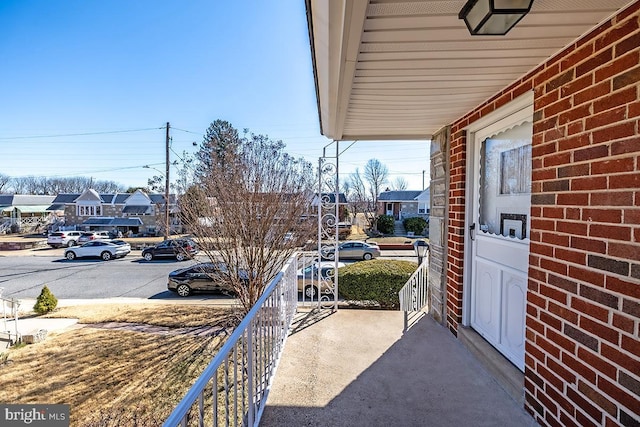 balcony featuring a porch and a residential view