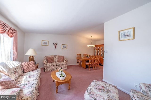 carpeted living area with baseboards, a notable chandelier, and vaulted ceiling