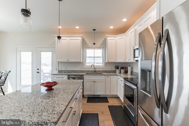 kitchen featuring recessed lighting, white cabinets, appliances with stainless steel finishes, and a sink