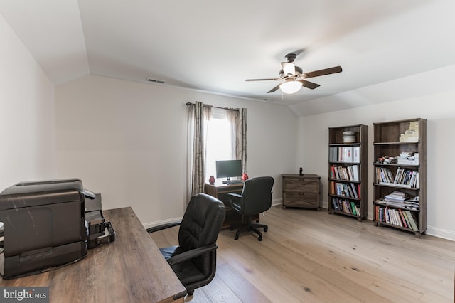 office space featuring baseboards, lofted ceiling, light wood-style floors, and ceiling fan