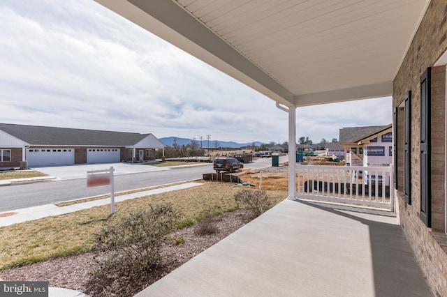 view of patio / terrace featuring a garage and a mountain view