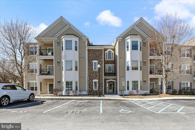 view of property featuring uncovered parking