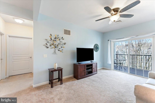 living area with a ceiling fan, carpet, visible vents, and baseboards