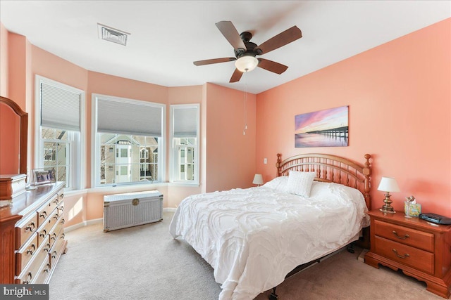 bedroom featuring visible vents, light carpet, a ceiling fan, radiator, and baseboards