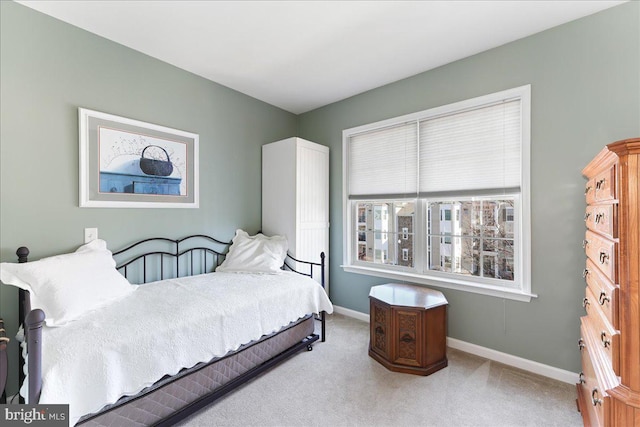 carpeted bedroom featuring baseboards