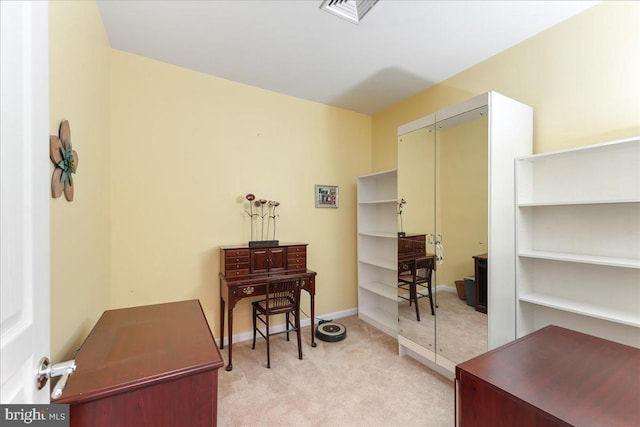 office featuring baseboards, visible vents, and light carpet