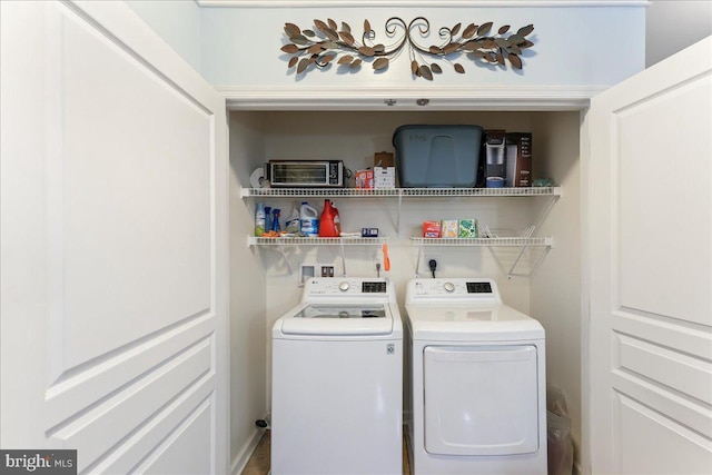 laundry area featuring separate washer and dryer and laundry area