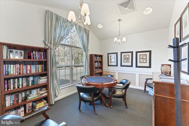 dining room featuring visible vents, dark carpet, a decorative wall, lofted ceiling, and a chandelier