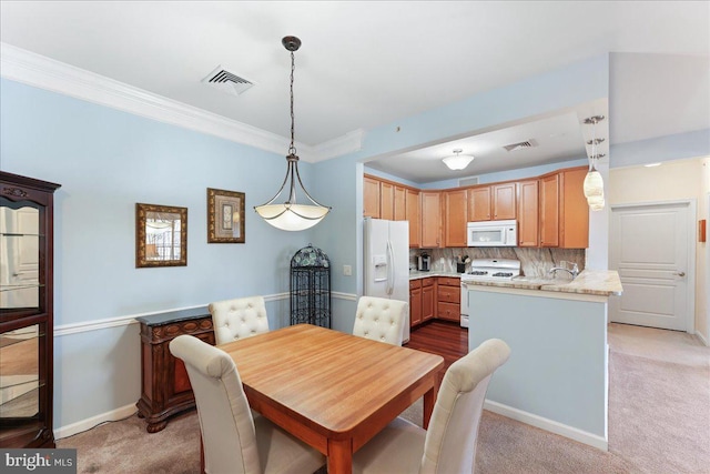 dining area with visible vents, light colored carpet, baseboards, and ornamental molding