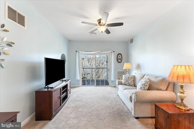 living room featuring visible vents, baseboards, light colored carpet, and ceiling fan