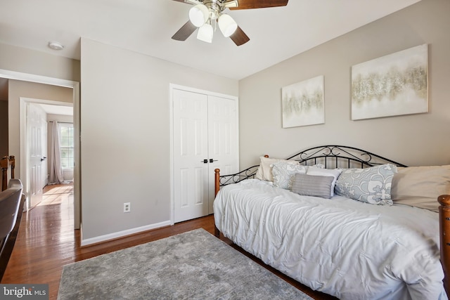 bedroom with a closet, a ceiling fan, baseboards, and wood finished floors