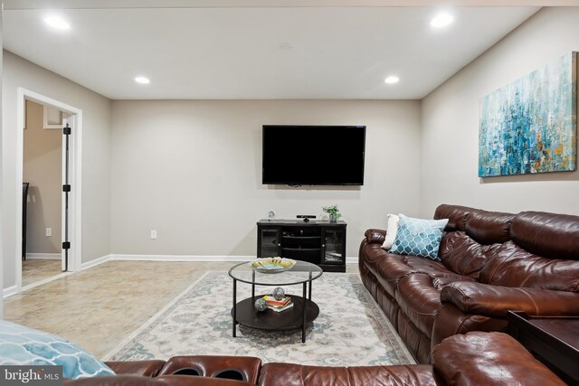 living room featuring recessed lighting and baseboards