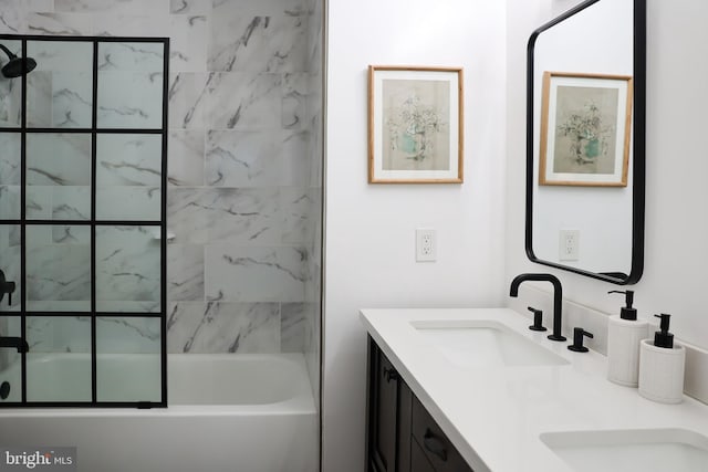 bathroom featuring double vanity, a sink, and bath / shower combo with glass door