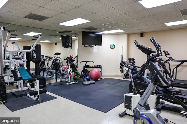 workout area with a drop ceiling and tile patterned floors