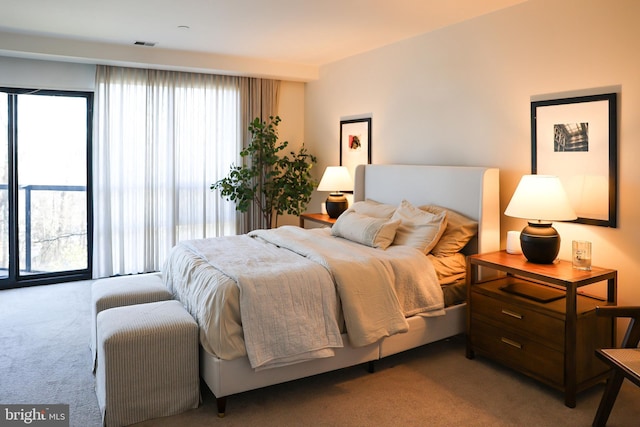 carpeted bedroom featuring visible vents