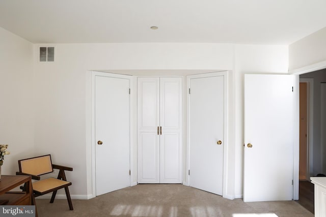 sitting room with light colored carpet and visible vents