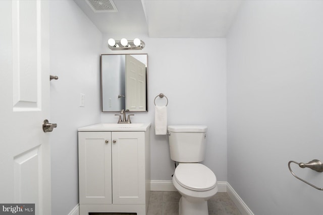 bathroom featuring visible vents, toilet, vanity, tile patterned flooring, and baseboards