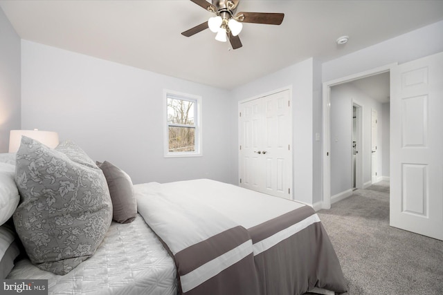 bedroom featuring ceiling fan, baseboards, a closet, and light colored carpet