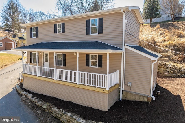 view of front of home featuring a porch and a shingled roof