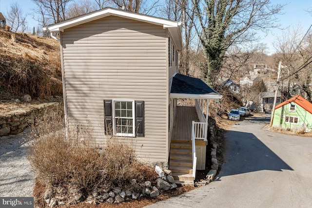 view of side of property featuring aphalt driveway