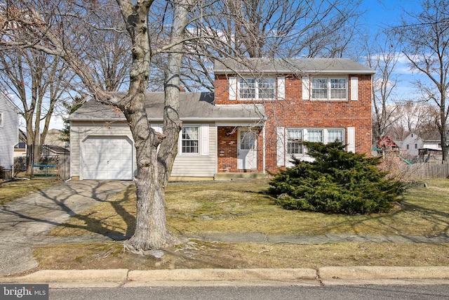 view of front facade with driveway, brick siding, an attached garage, fence, and a front yard