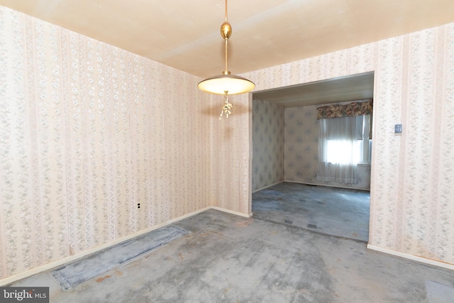 unfurnished dining area with baseboards, carpet flooring, and wallpapered walls