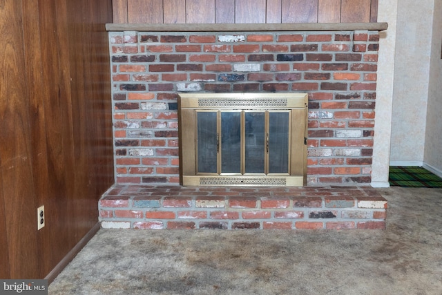 details with a brick fireplace and carpet flooring